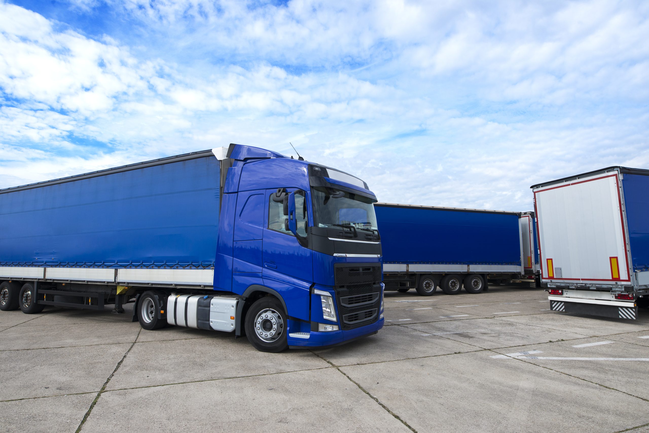 Truck vehicle with trailers in background.